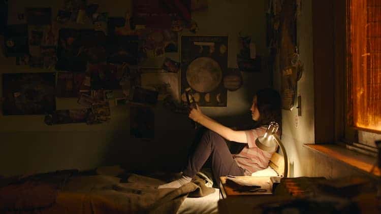 Ellie sitting on her bed in the FEDRA Training academy