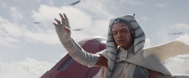 Ahsoka, dressed in white, closes her eyes and reaches out with her right hand, trying to commune with a purrgil