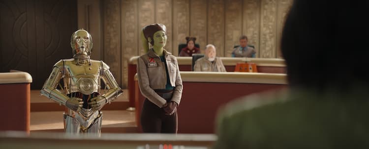 Hera and C3PO stand before a Senate Committee in a courtroom. Carson Teva and Chopper sit in the background