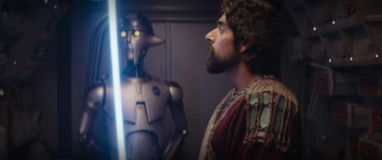 Ezra inspects his new blue lightsaber onboard the Jedi Shuttle with Huyang in the background