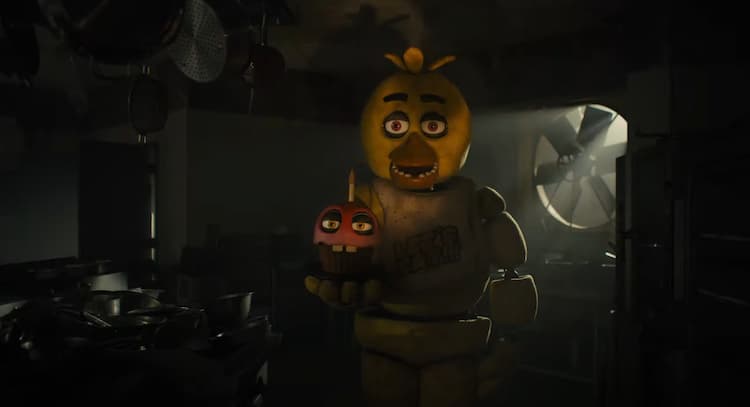 Chica is standing in a dimly lit room holding their cupcake. The only light is coming through a fan duct behind Chica. Pots and pans are scattered around the room.