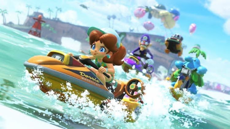 Daisy, Walugi, Pinta, and Shy Guy are racing through the water. Daisy is in the front with a determined look on her face. A rock formation is in the background. Trees are on the rock formation. A buoy is in the water.